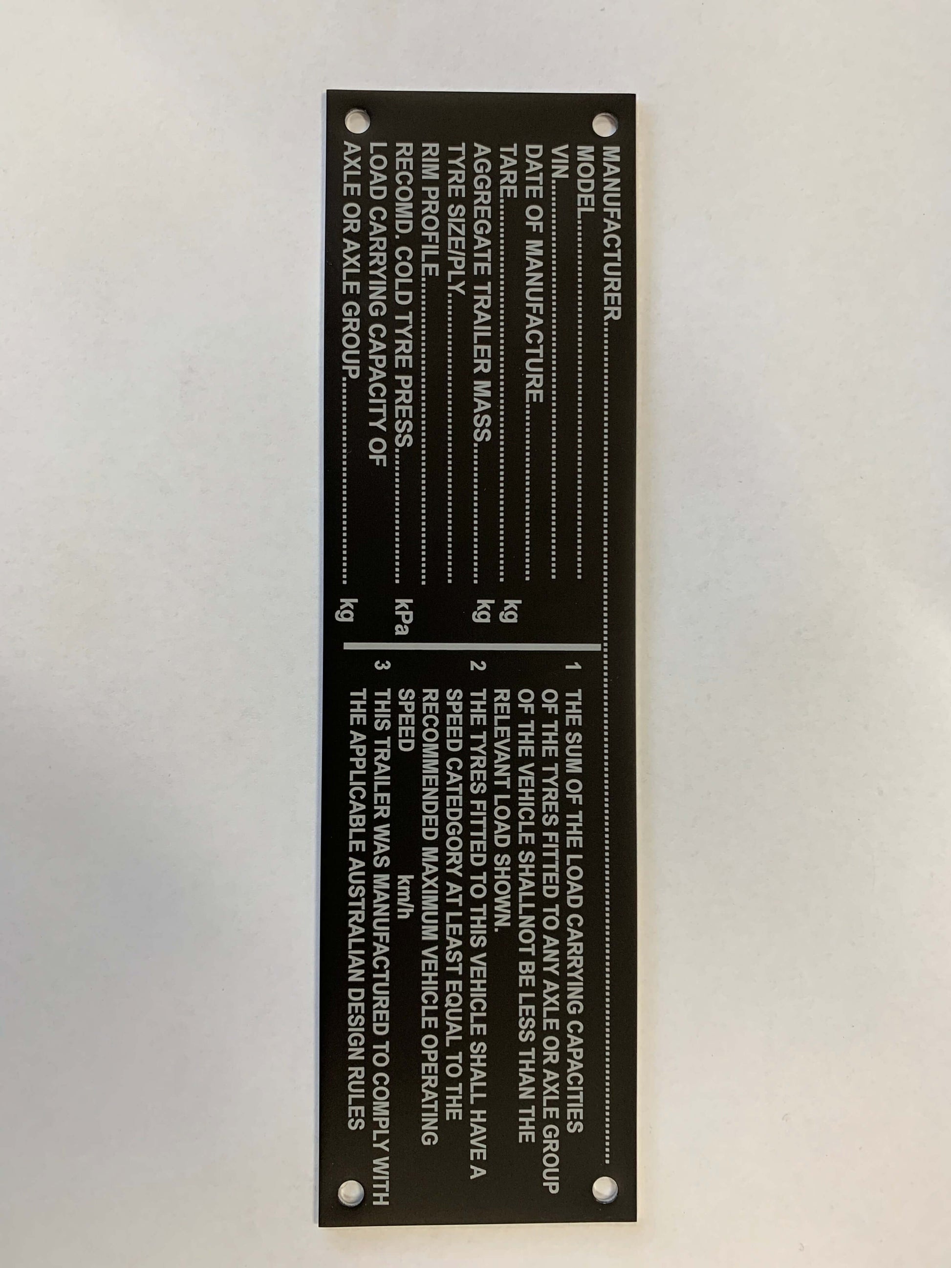 Black aluminum VIN compliance plate with manufacturer details, weight specifications, and 4 holes for mounting.